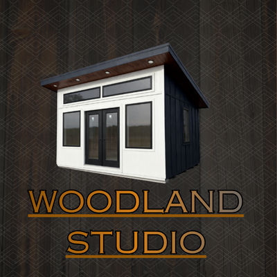 A modern white building with black-framed windows next to a red bench on a concrete patio, with green trees in the background.