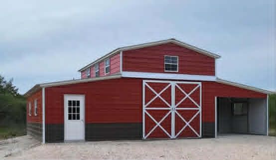 Red barn with white trim and doors, attached open shed, on gravel under cloudy sky