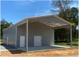 Open-sided gray metal storage shed with two white doors and a sloped roof on a dirt lot.