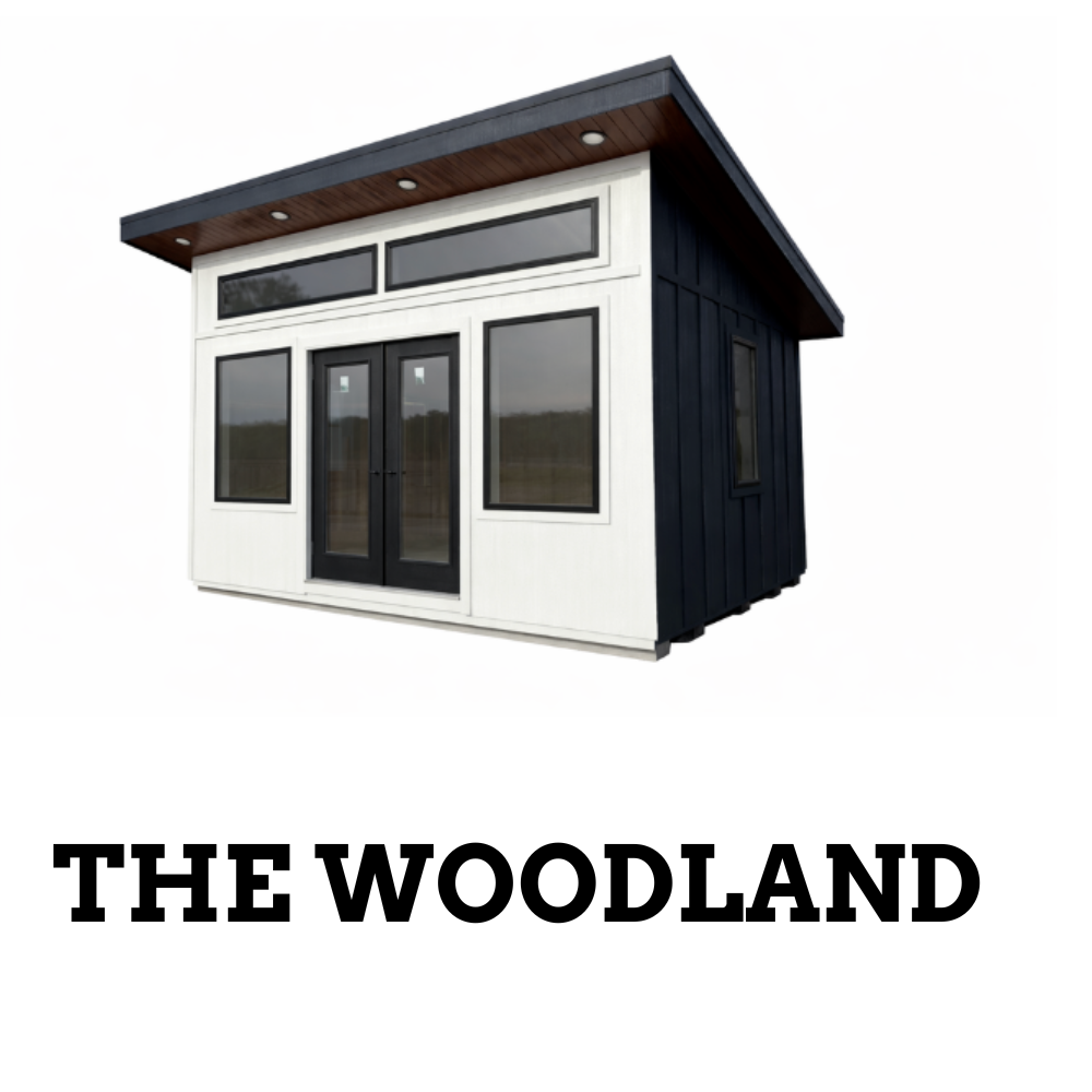 The Woodland: A modern, white-and-dark-sided backyard studio shed with a slanted roof and glass double doors.