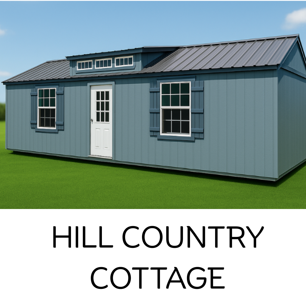 A light blue, rectangular portable cottage with a dark metal roof, white door, and windows on a grass field.