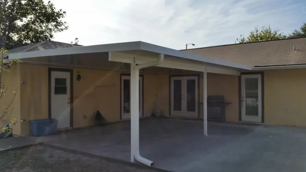 A house with a covered patio in front of it.