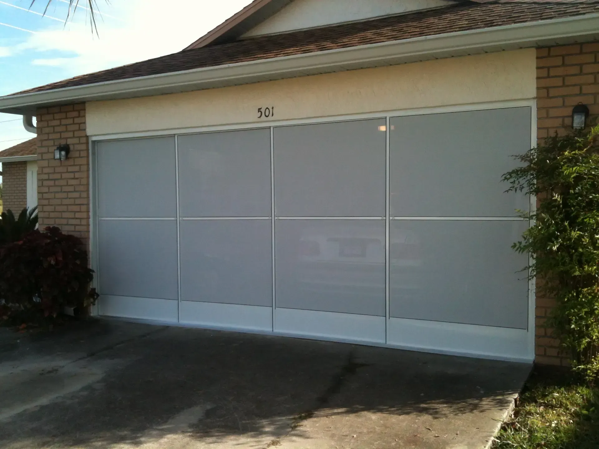 A white garage door with a screen on it