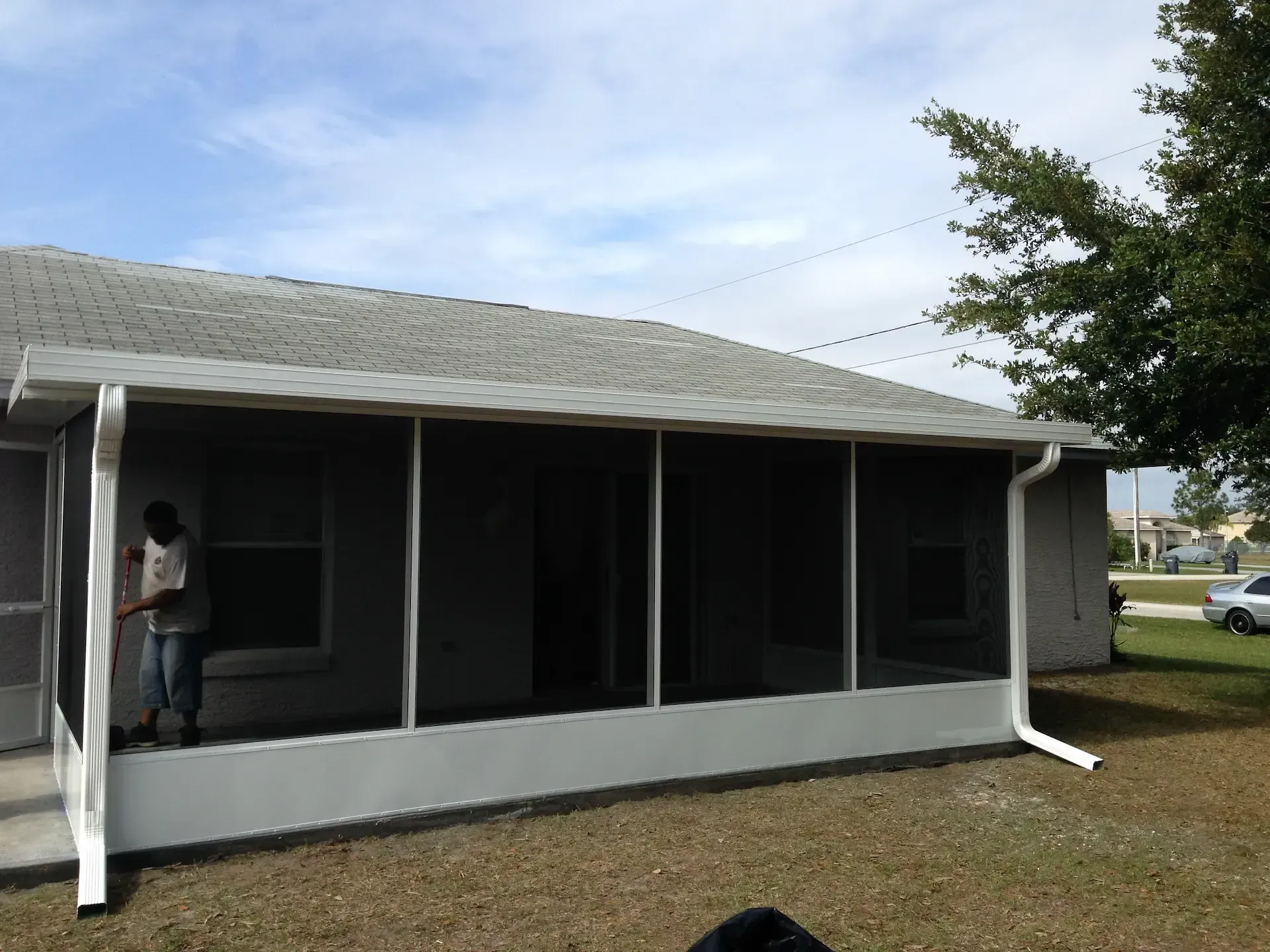 A screened in porch in front of a house