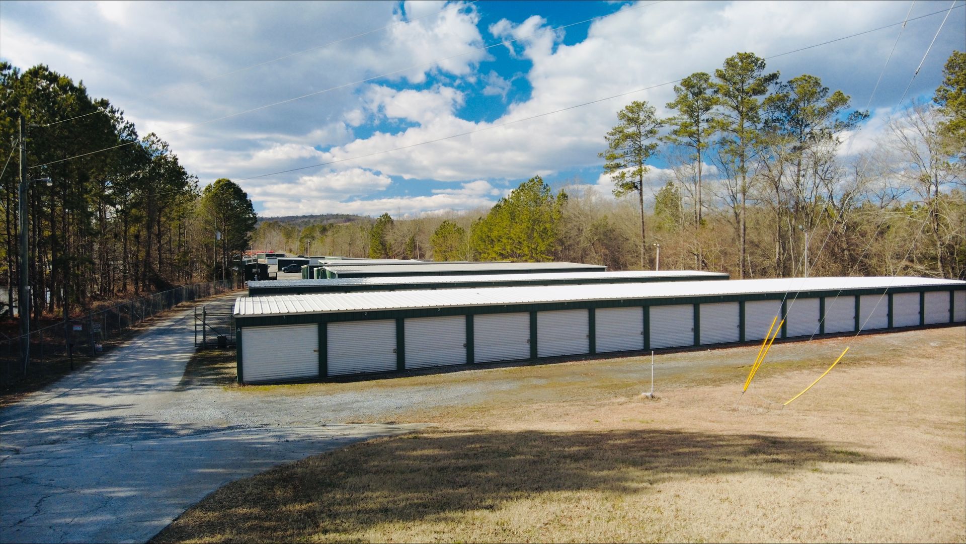 A row of storage units in a field with trees in the background - Rome, GA - Armuchee Self Storage