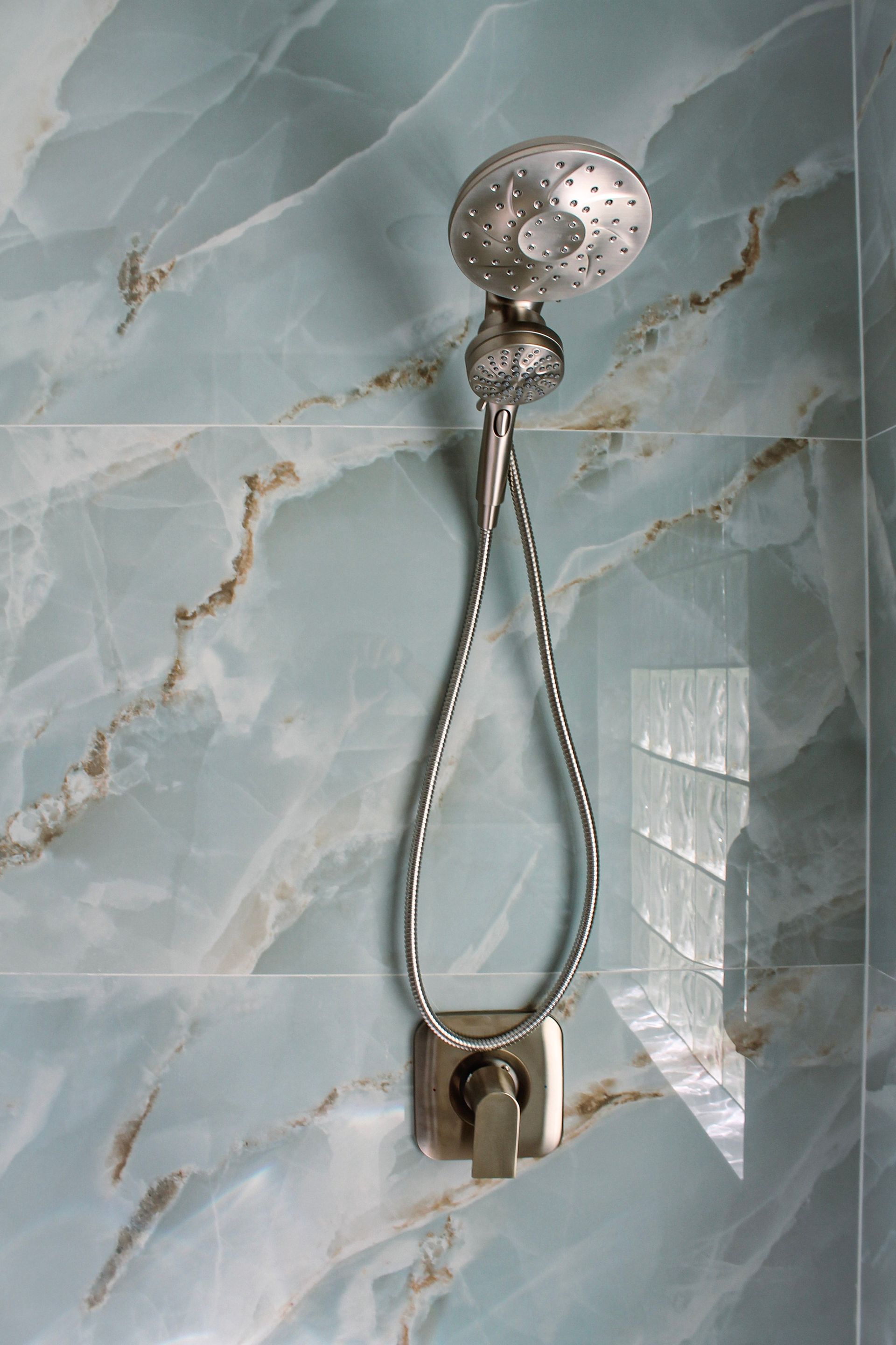 Modern brushed stainless steel shower head, spa style bathroom showerhead with modern look, modern blue large form tile with white grout