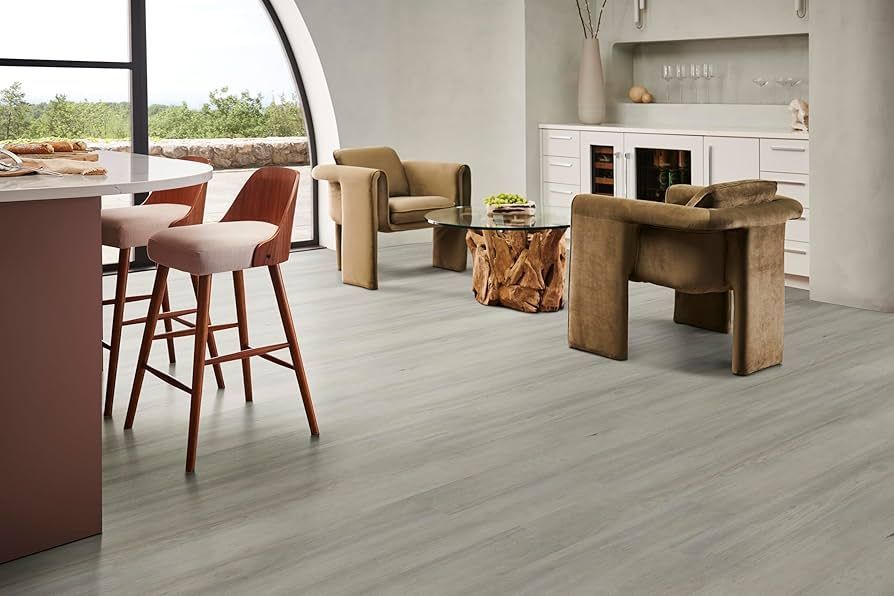 A living room with a table , chairs , and stools.