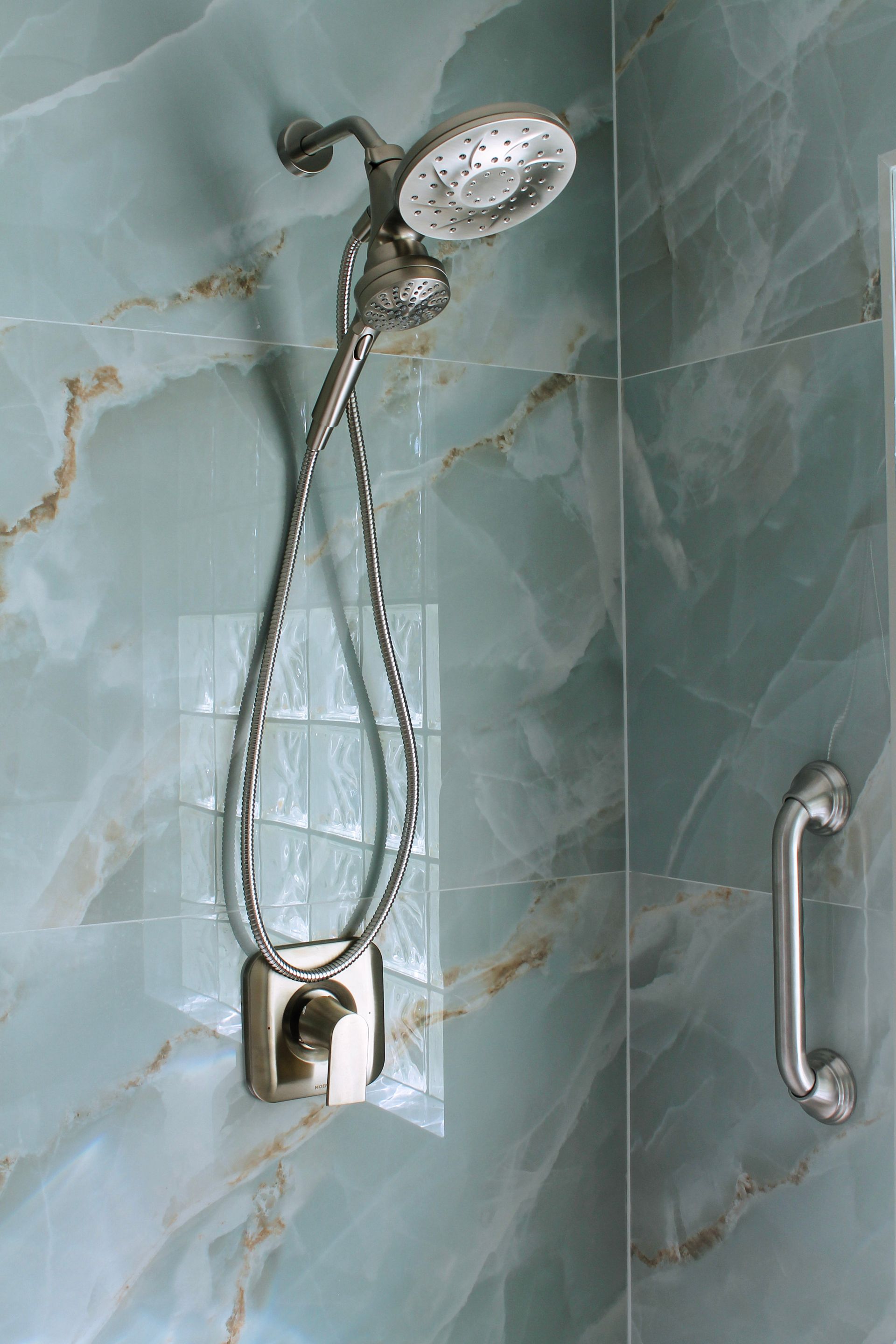 Blue tile bathroom with brushed stainless steel trim and modern small grout lines