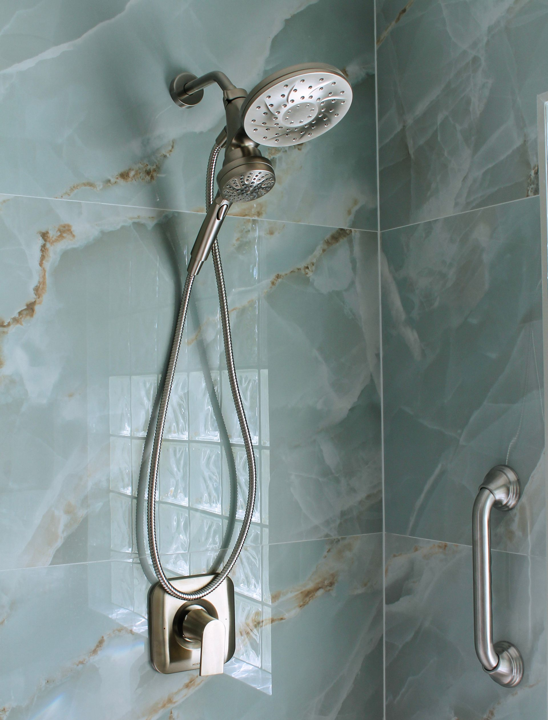 Blue tile bathroom with brushed stainless steel trim and modern small grout lines