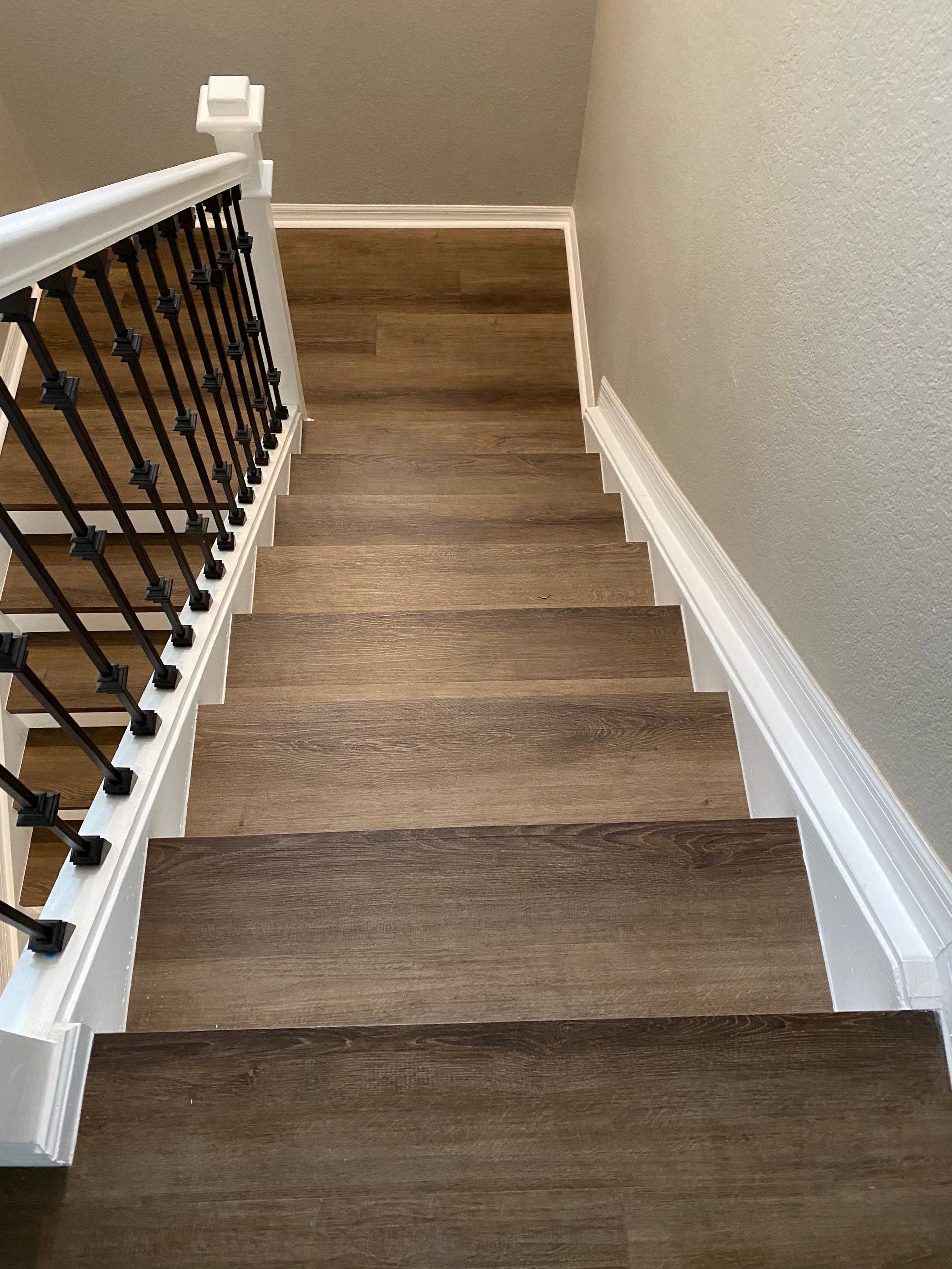 Brown wooden stairs with hand railing