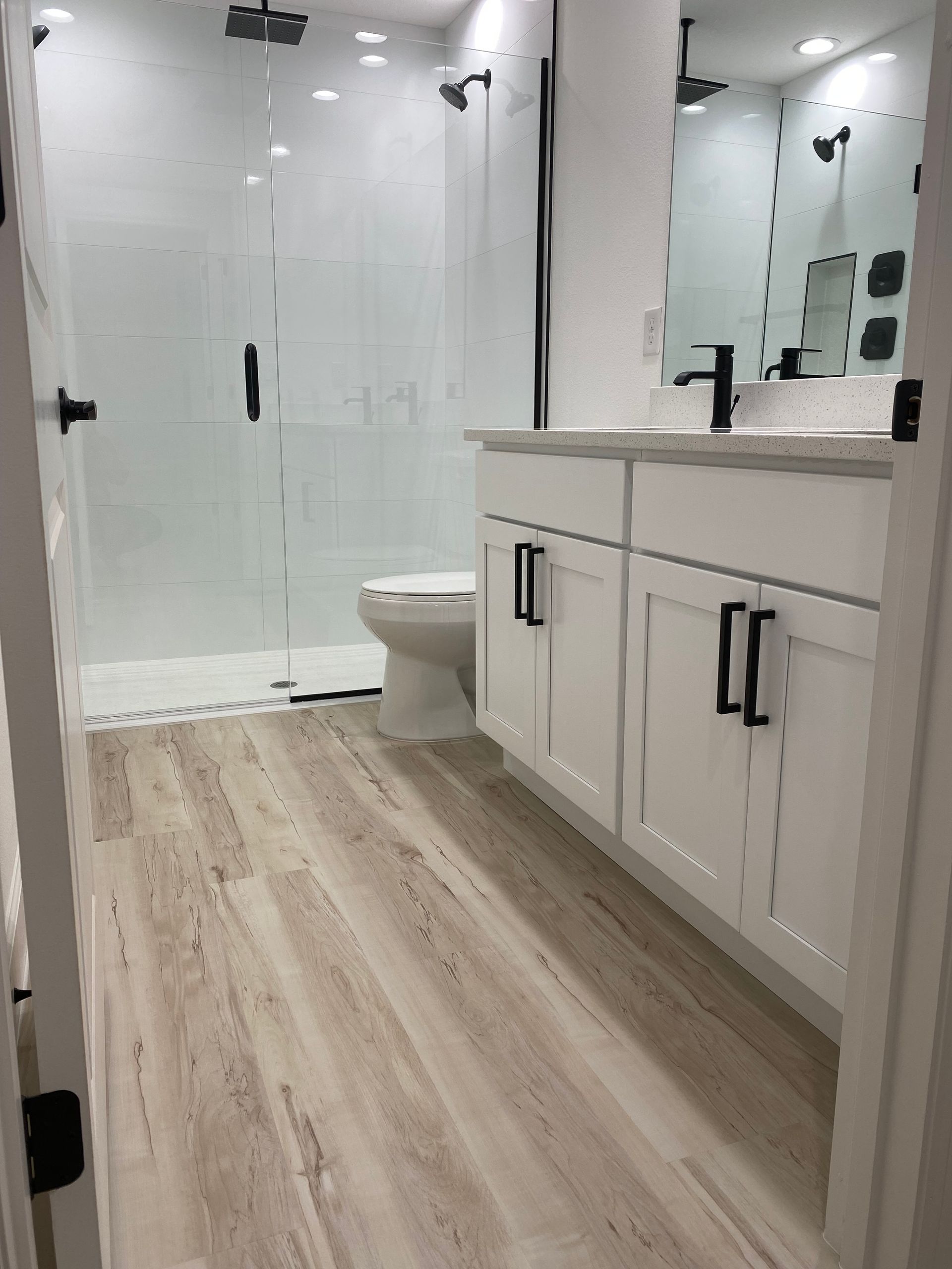 A bathroom with a toilet , sink , and shower.