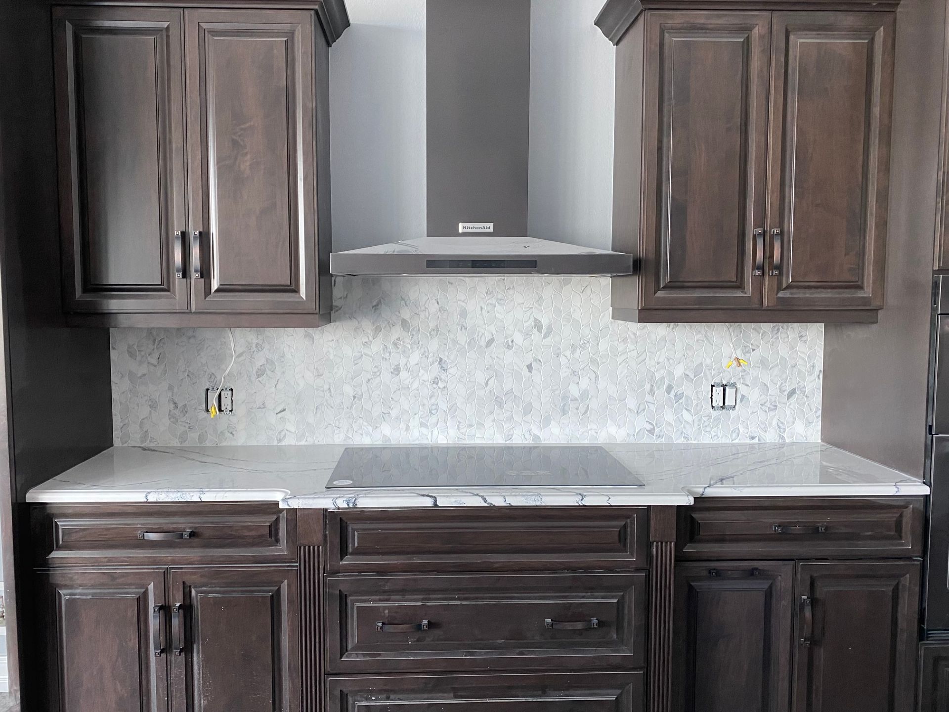 A kitchen with wooden cabinets and a stove top oven