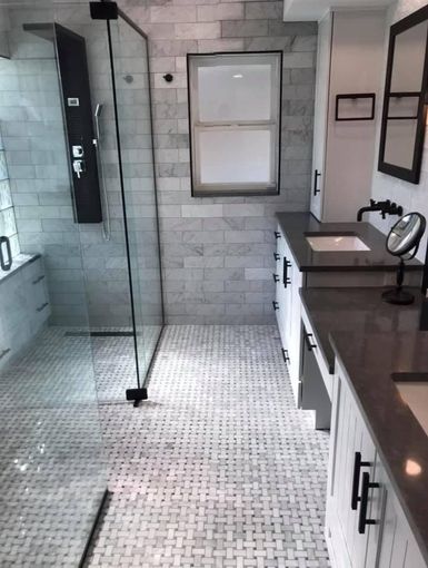 A bathroom with a shower and a bench in it