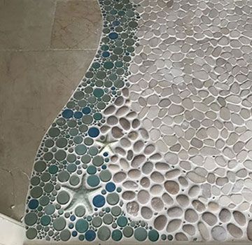 A close up of a tiled floor with a starfish on it.