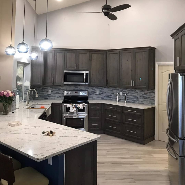 A kitchen with stainless steel appliances and wooden cabinets.