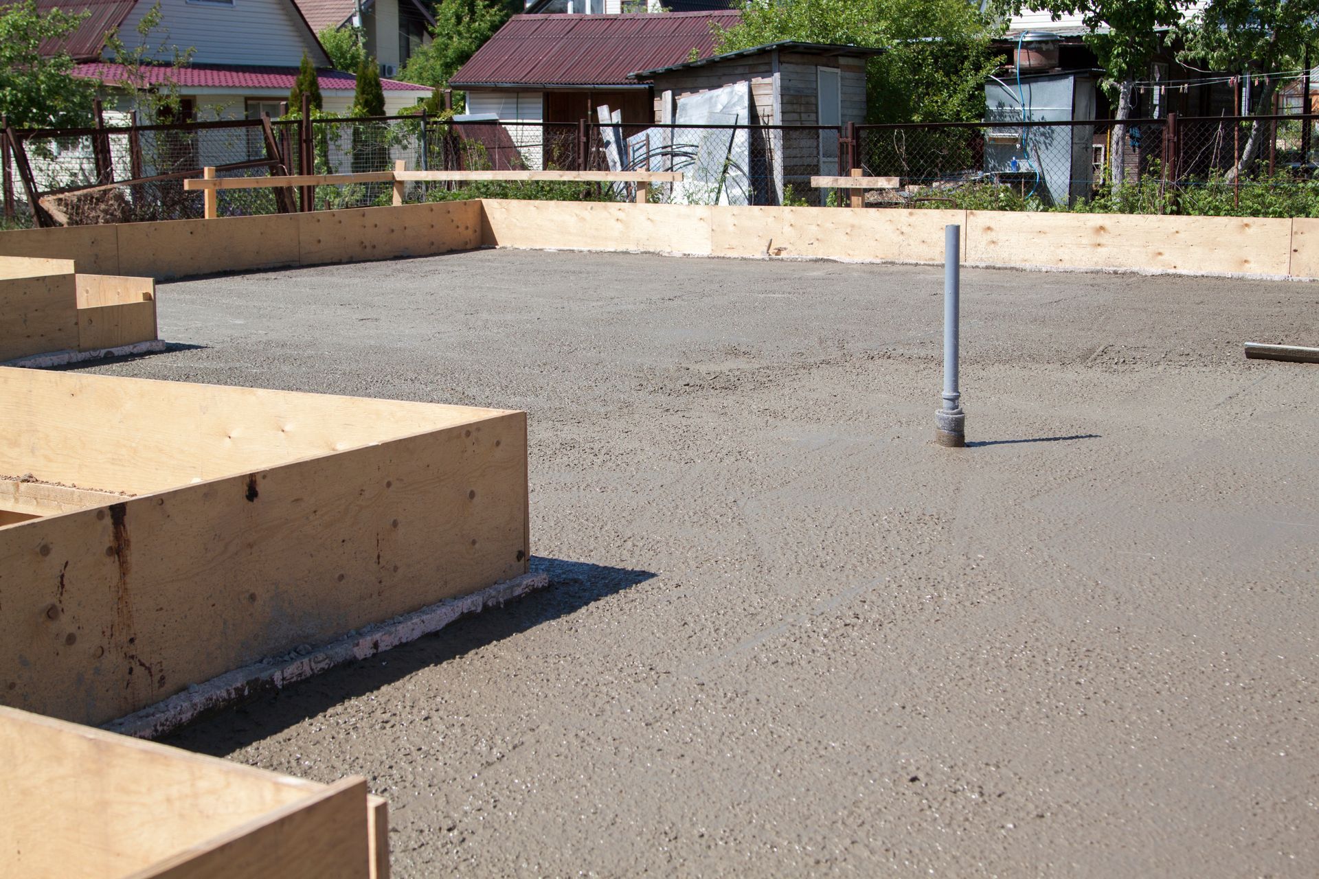 Concrete slab of foundation with wooden formwork.