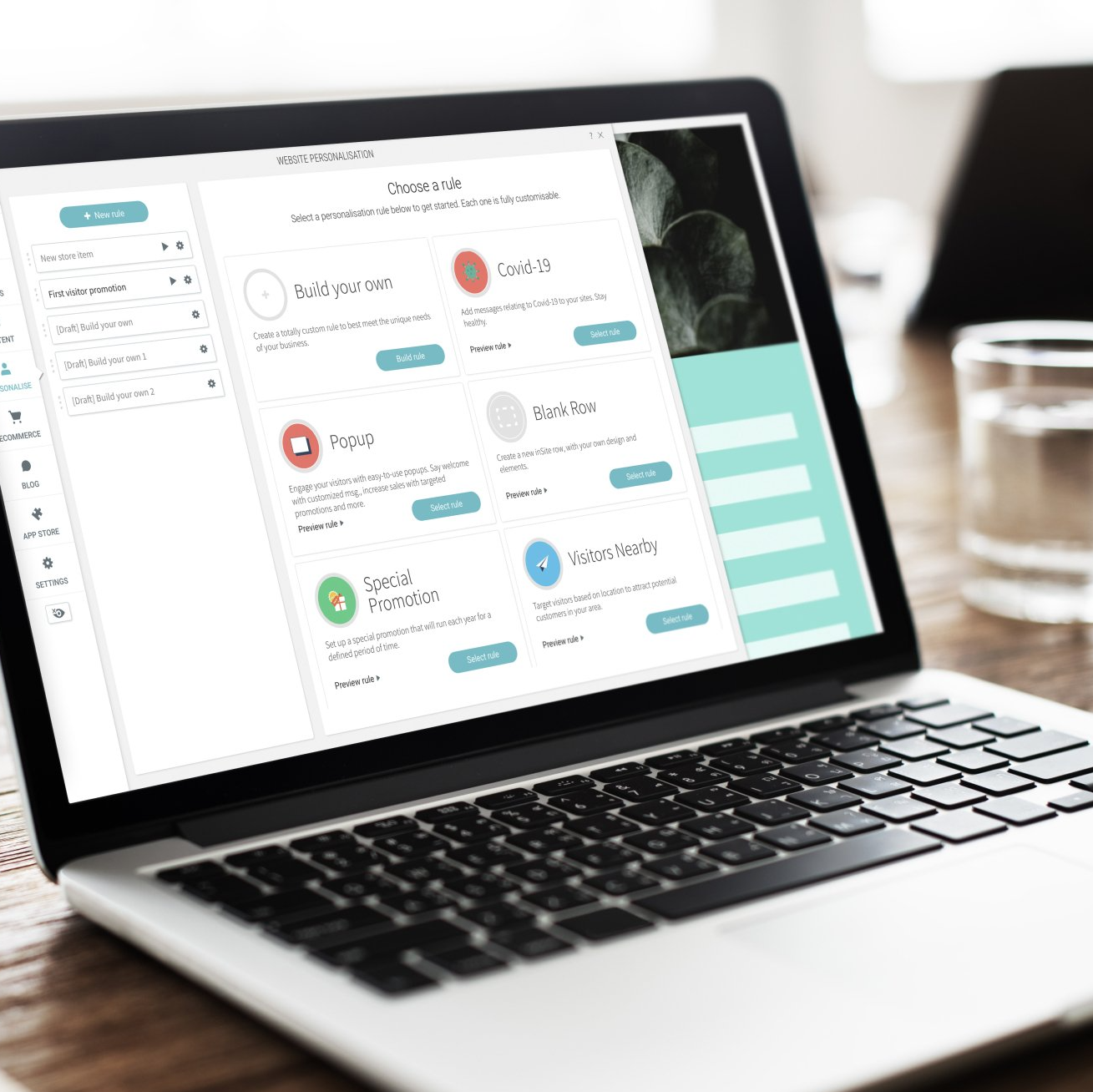 Laptop displaying a digital interface with options and descriptions, set on a wooden table.