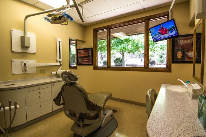 a dental office with a dental chair and a sink .