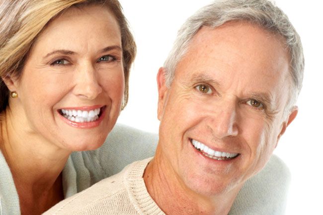 a man and a woman are smiling for the camera .