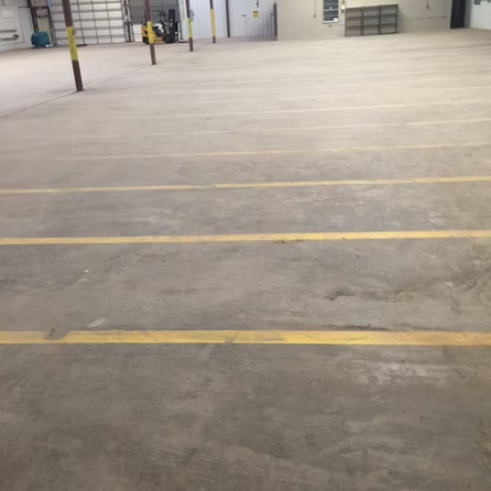 An empty parking lot with yellow lines on the floor