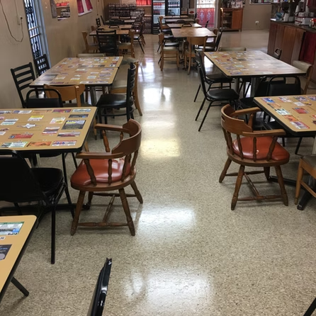 A dining room with tables and chairs in it