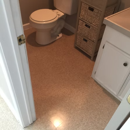 A bathroom with a toilet and wicker drawers