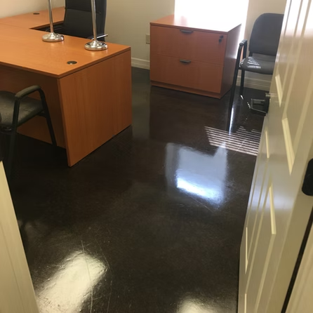 A room with a desk and chairs in it