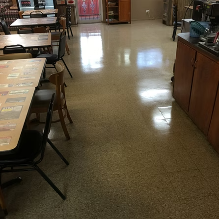 A dining room with tables and chairs and a counter