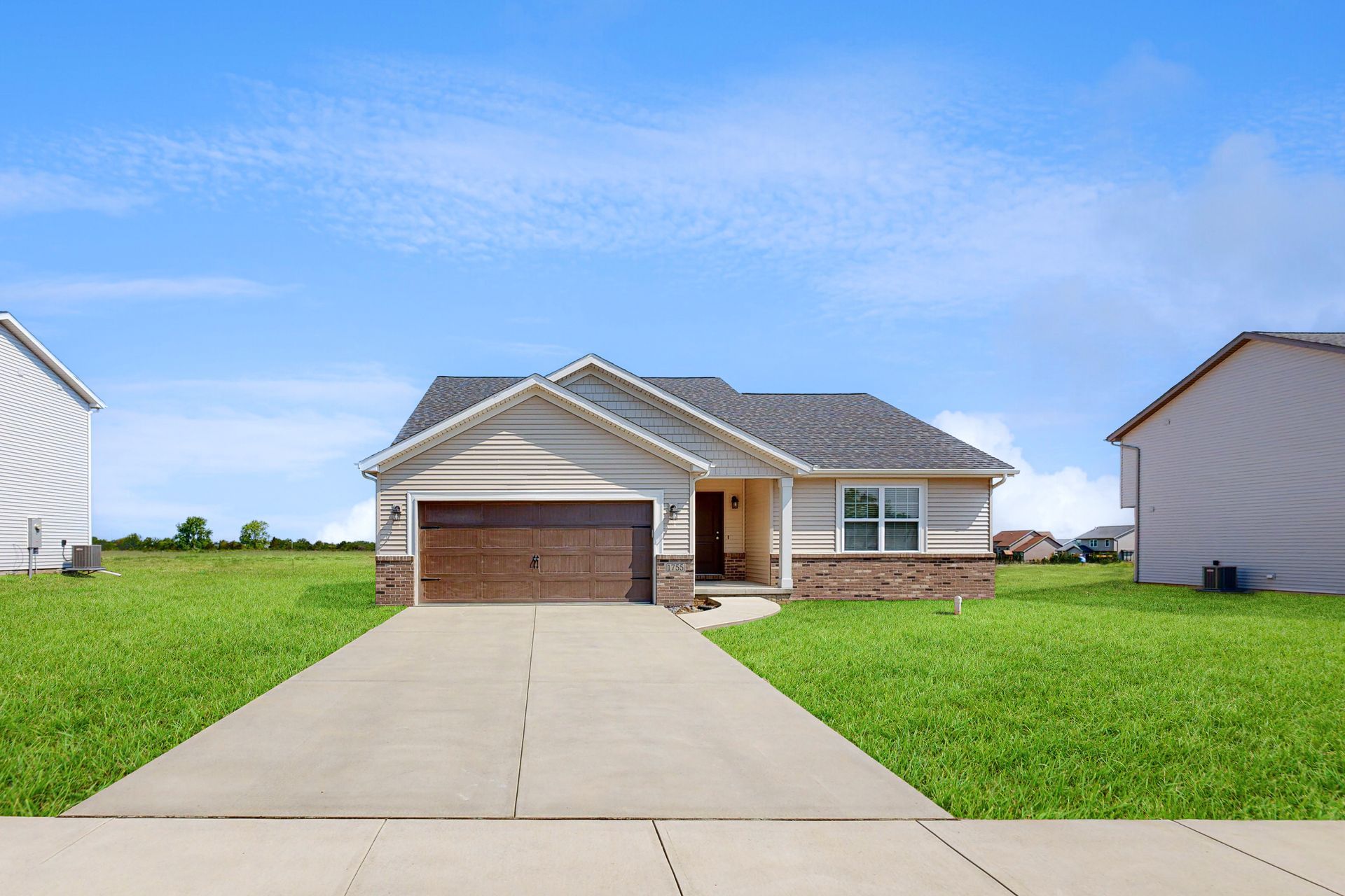 A house with a concrete driveway leading to it