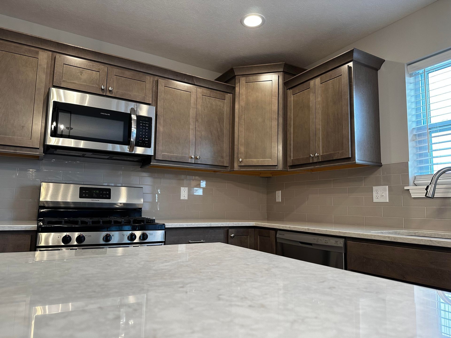 A kitchen with stainless steel appliances and wooden cabinets