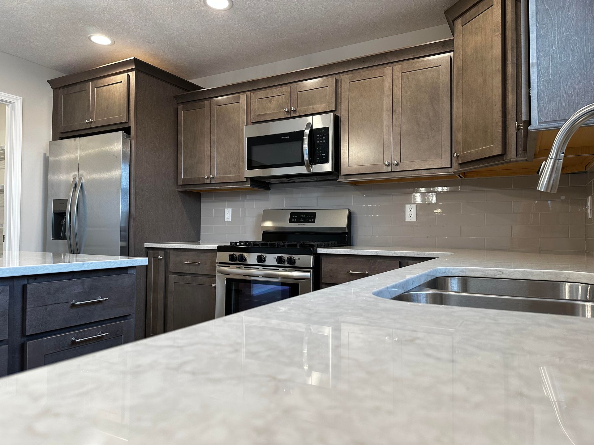 A kitchen with stainless steel appliances and wooden cabinets