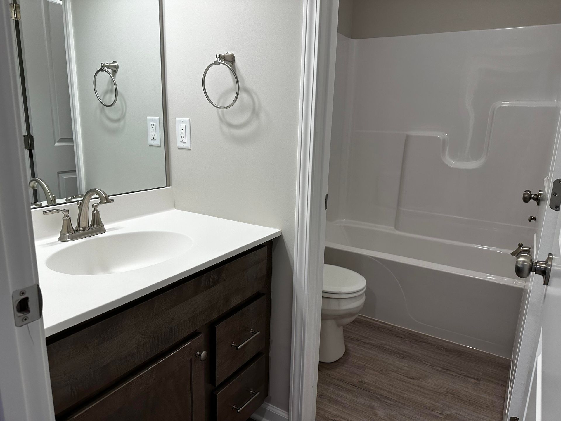 A bathroom with a sink , toilet , and bathtub.