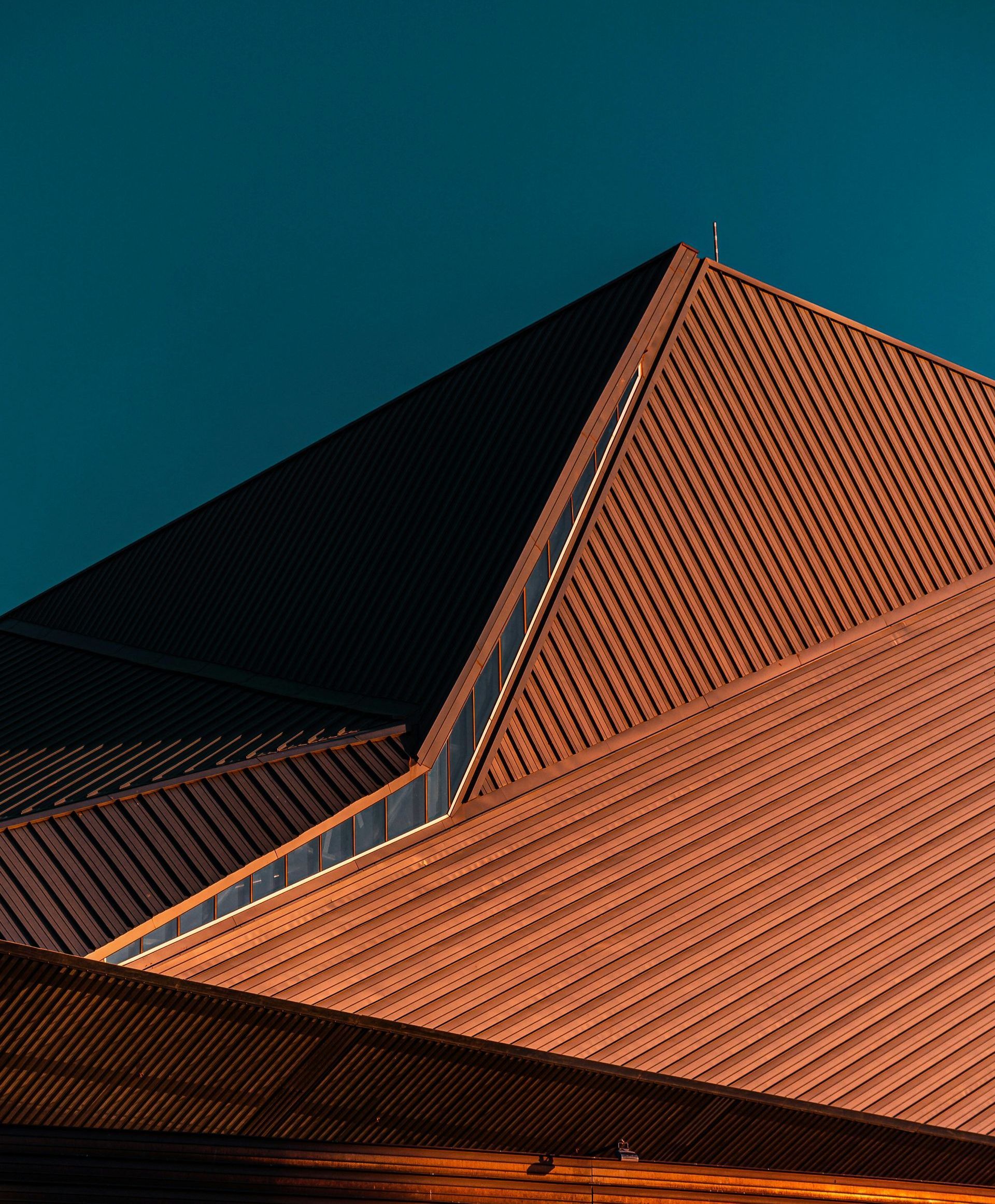 The roof of a building with a blue sky in the background