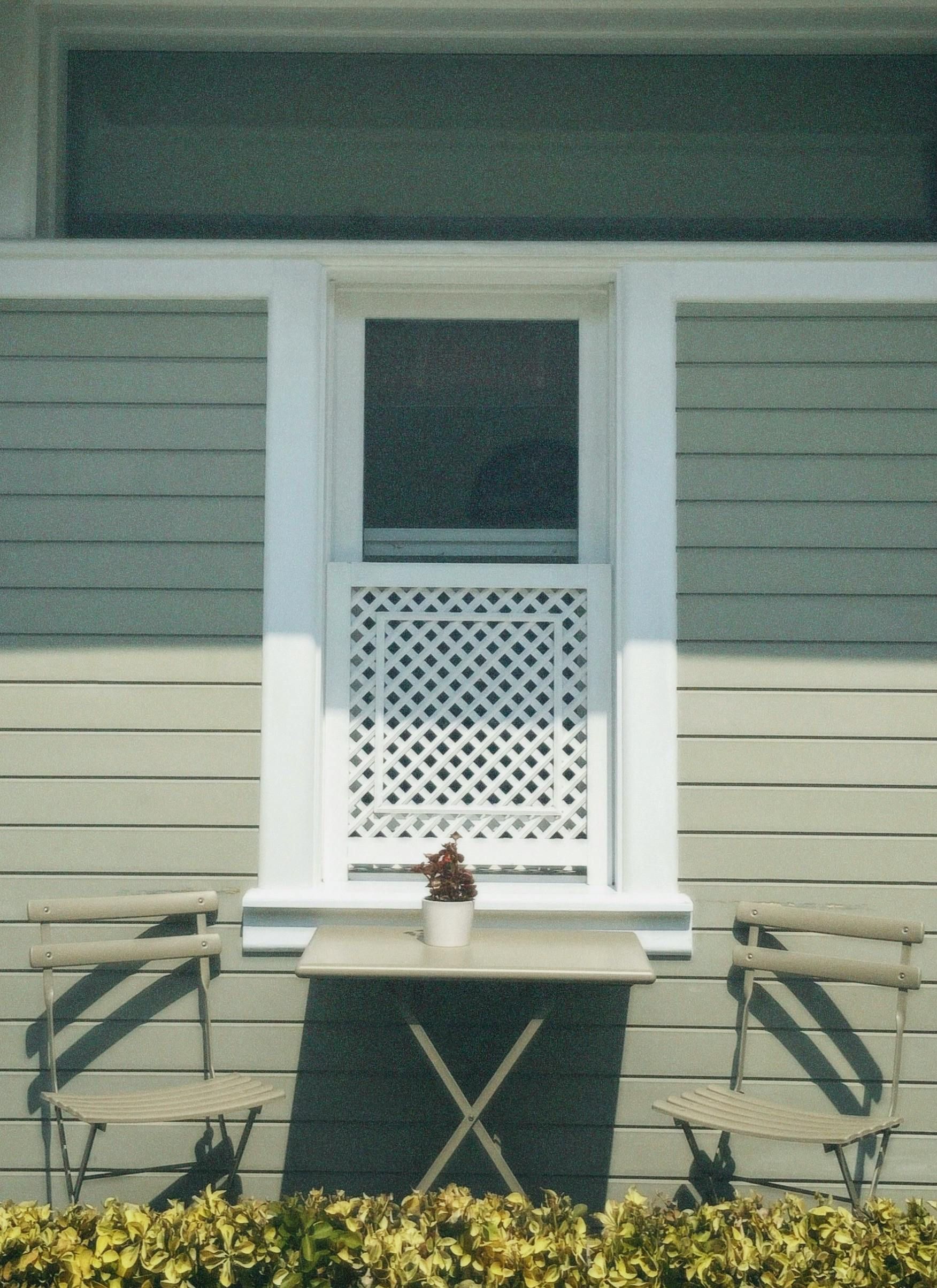 A table with an x on it sits in front of a house