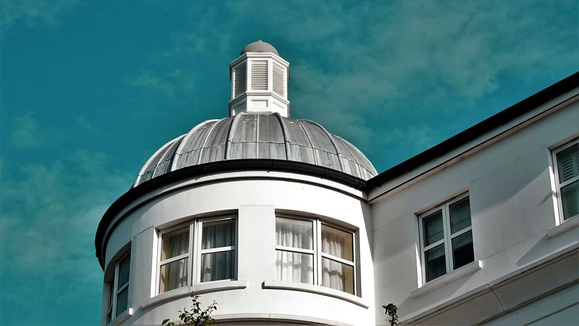 A white building with a dome on top of it