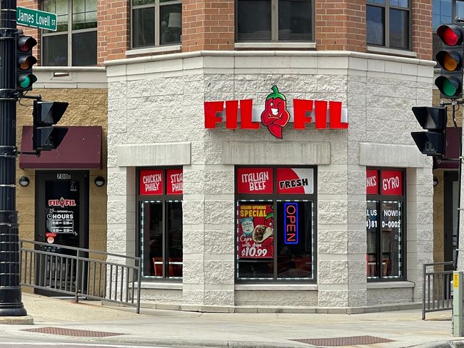 A fil fil restaurant is located on the corner of downtown Milwaukee city street