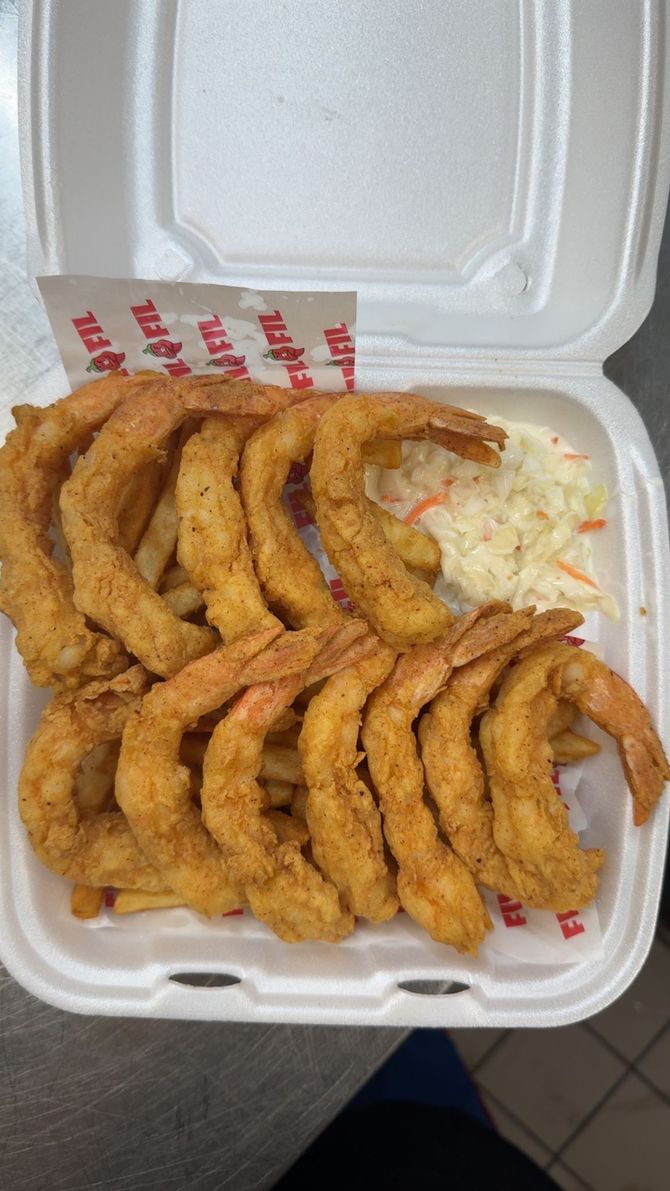 Fried shrimp and fries in a white container with coleslaw.