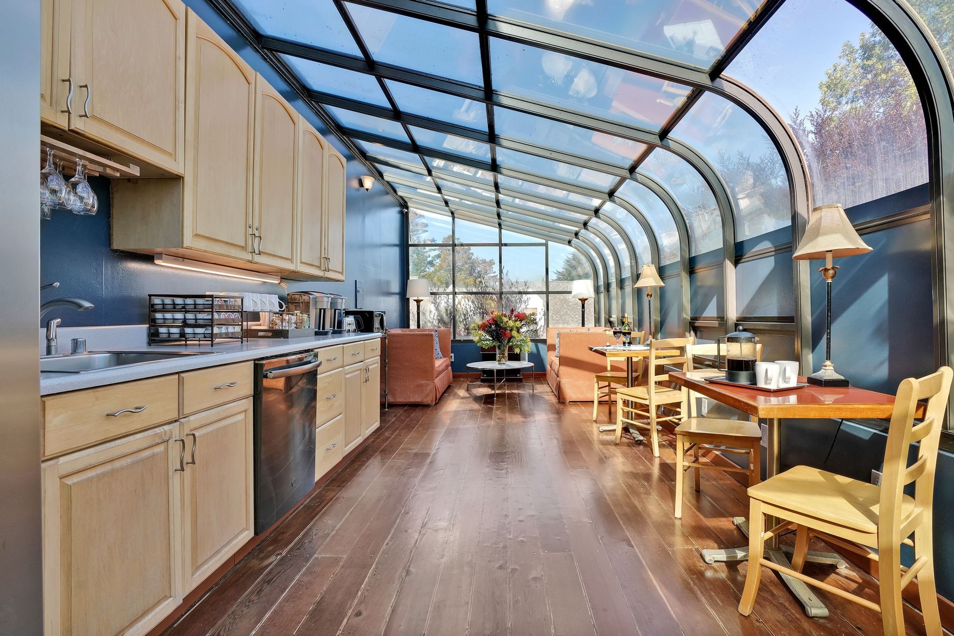 A kitchen with wooden cabinets and a glass roof
