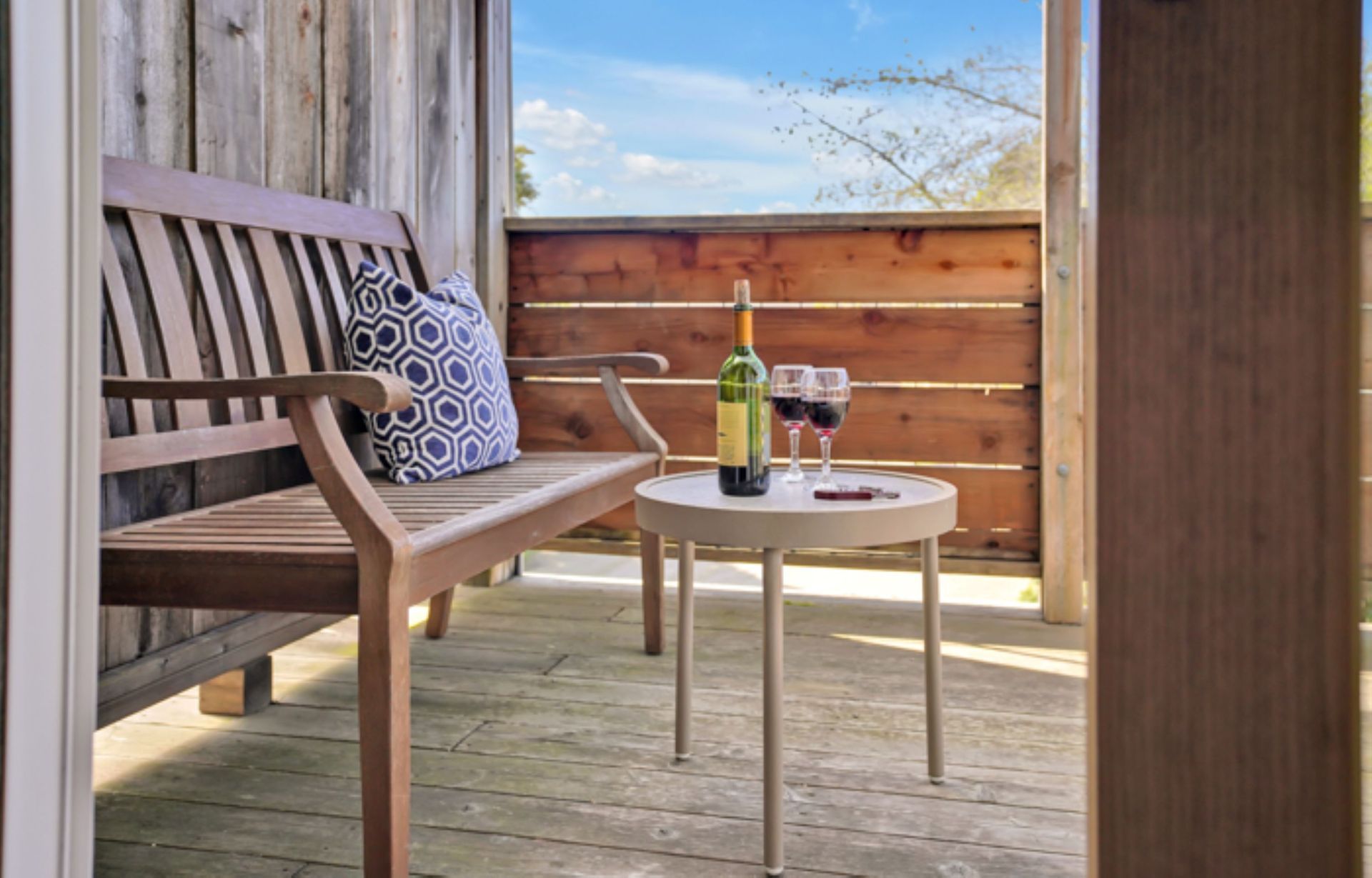 A table with a bottle of wine and two glasses on it