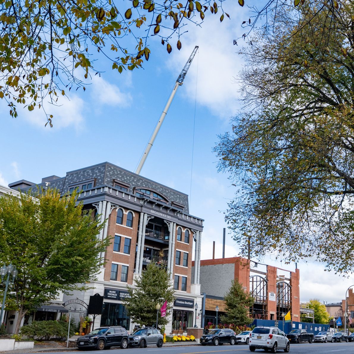 A large building under construction with a crane in the background
