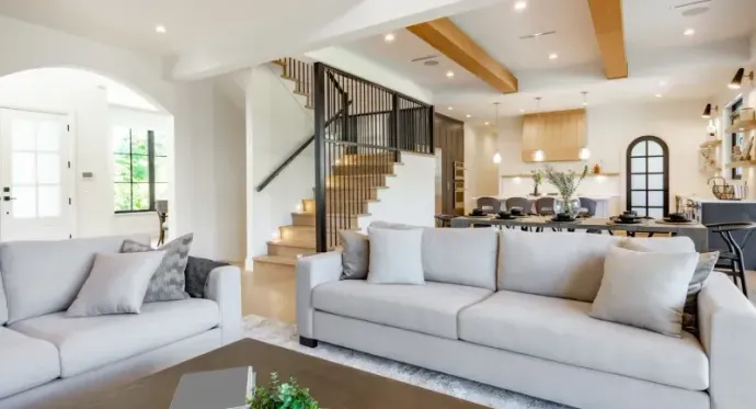 A living room with two white couches and a coffee table.