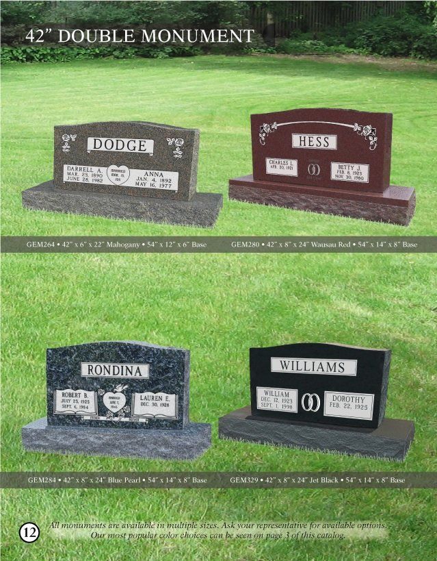 Four graves are sitting on top of a lush green field.