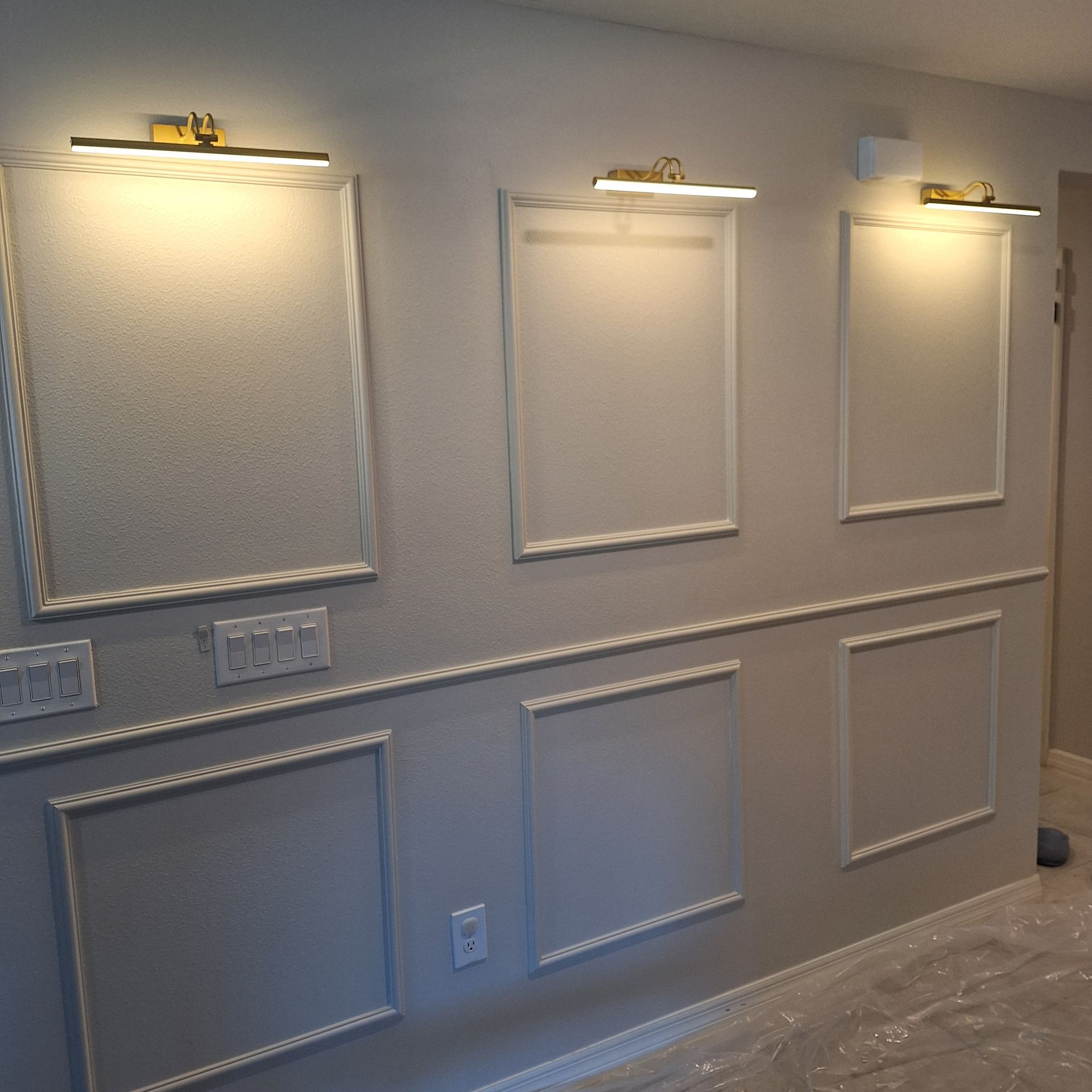 A hallway with a lot of picture frames on the wall