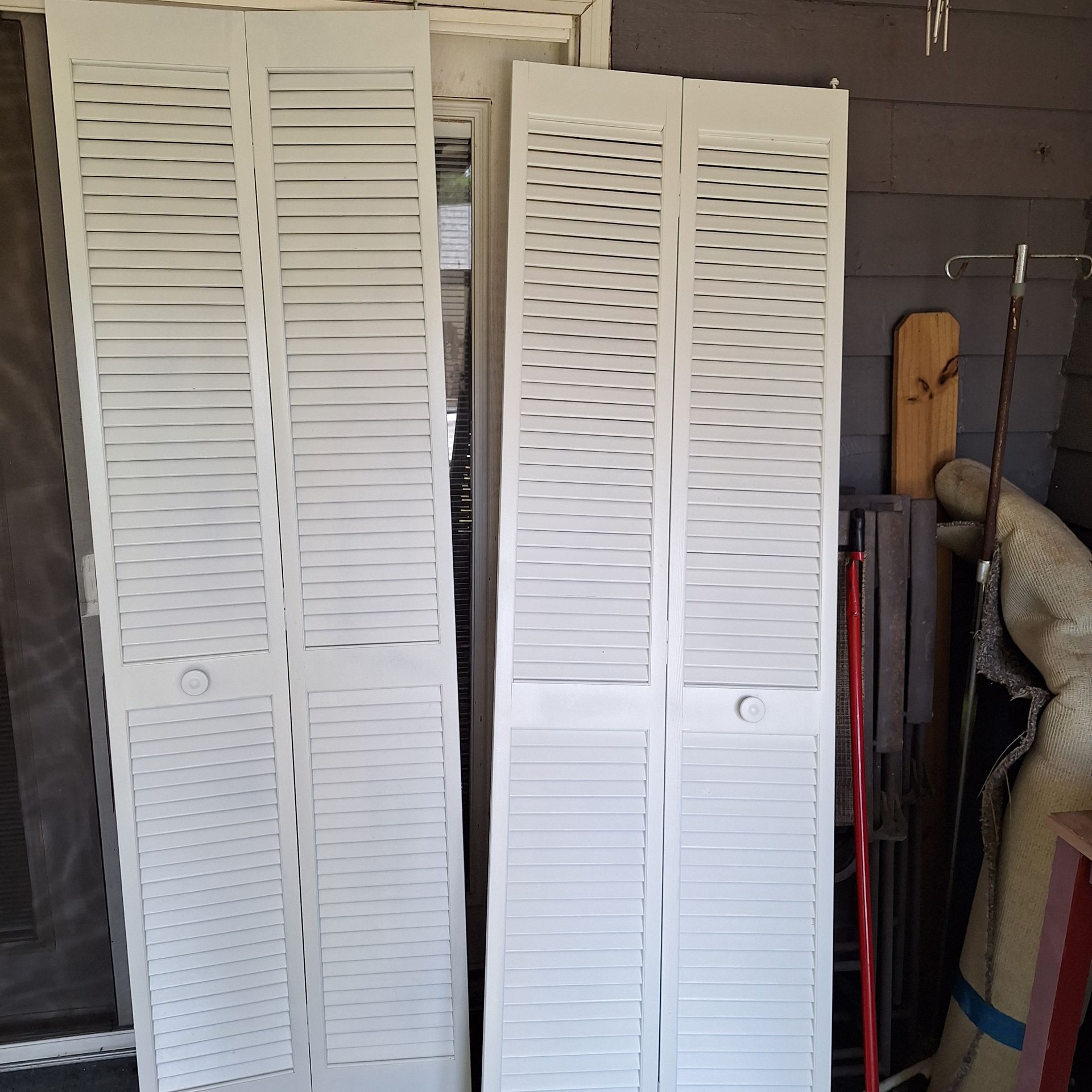 A pair of white shutters sitting next to each other