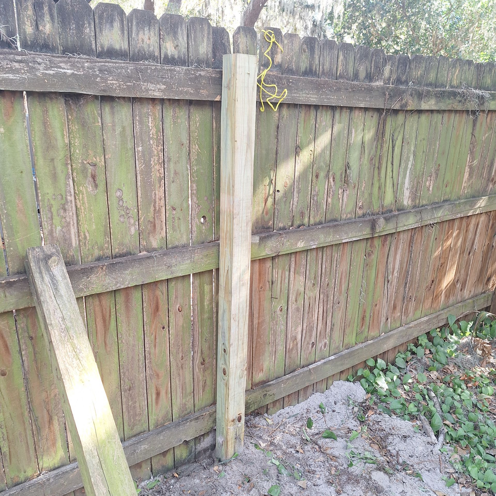 A wooden fence with a wooden post attached to it
