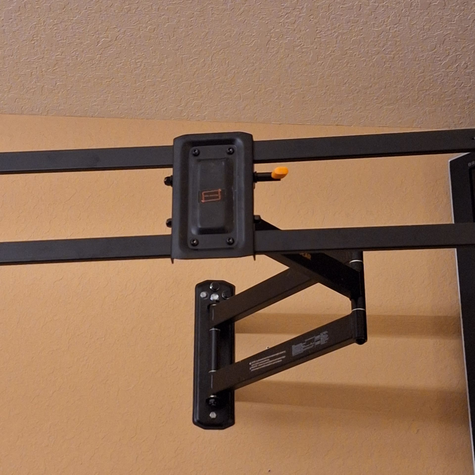 A basketball hoop is mounted to a wall with a bracket that says ' nba ' on it