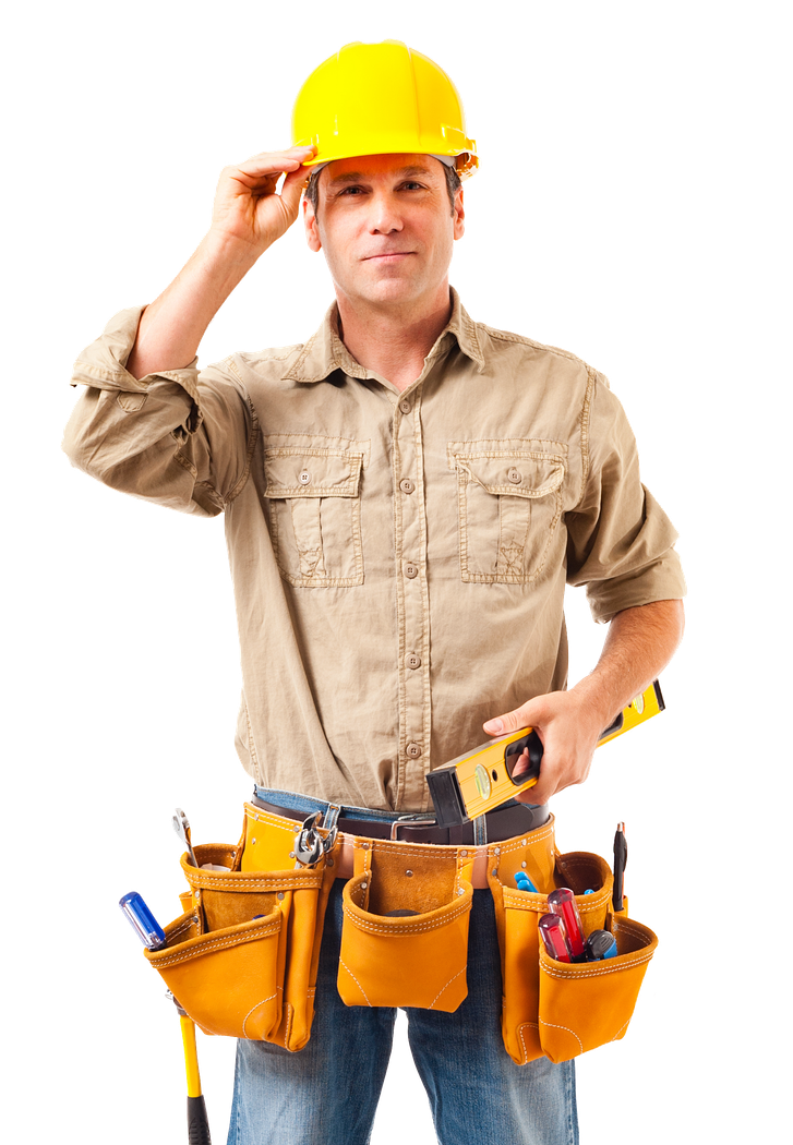 A man wearing a hard hat and tool belt is holding a tape measure.