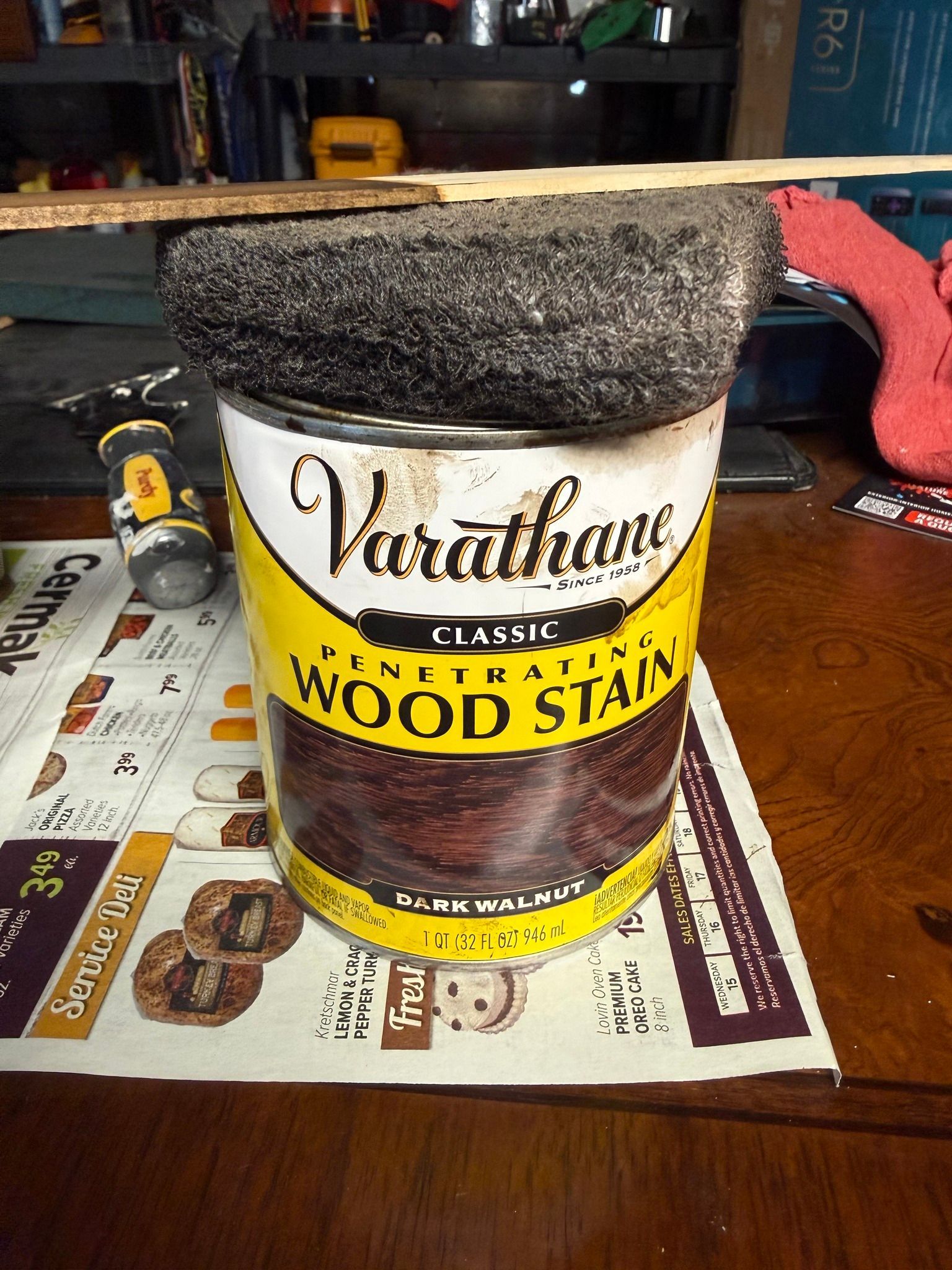 Varathane wood stain can with dark lid on a wooden table, photographed close up