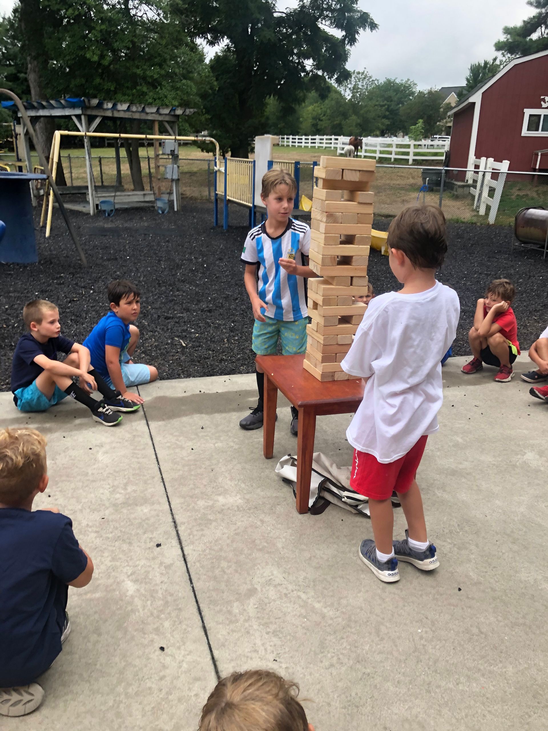 A group of children are playing a game called jenga