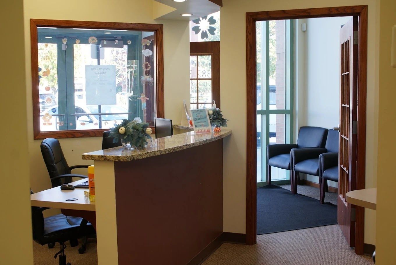Reception area with a desk, chairs, and a waiting area visible.